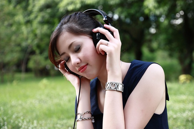 Girl listens to audio on headphones