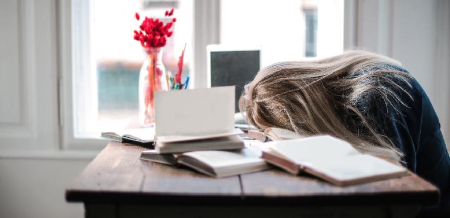 Woman putting her head down on her desk