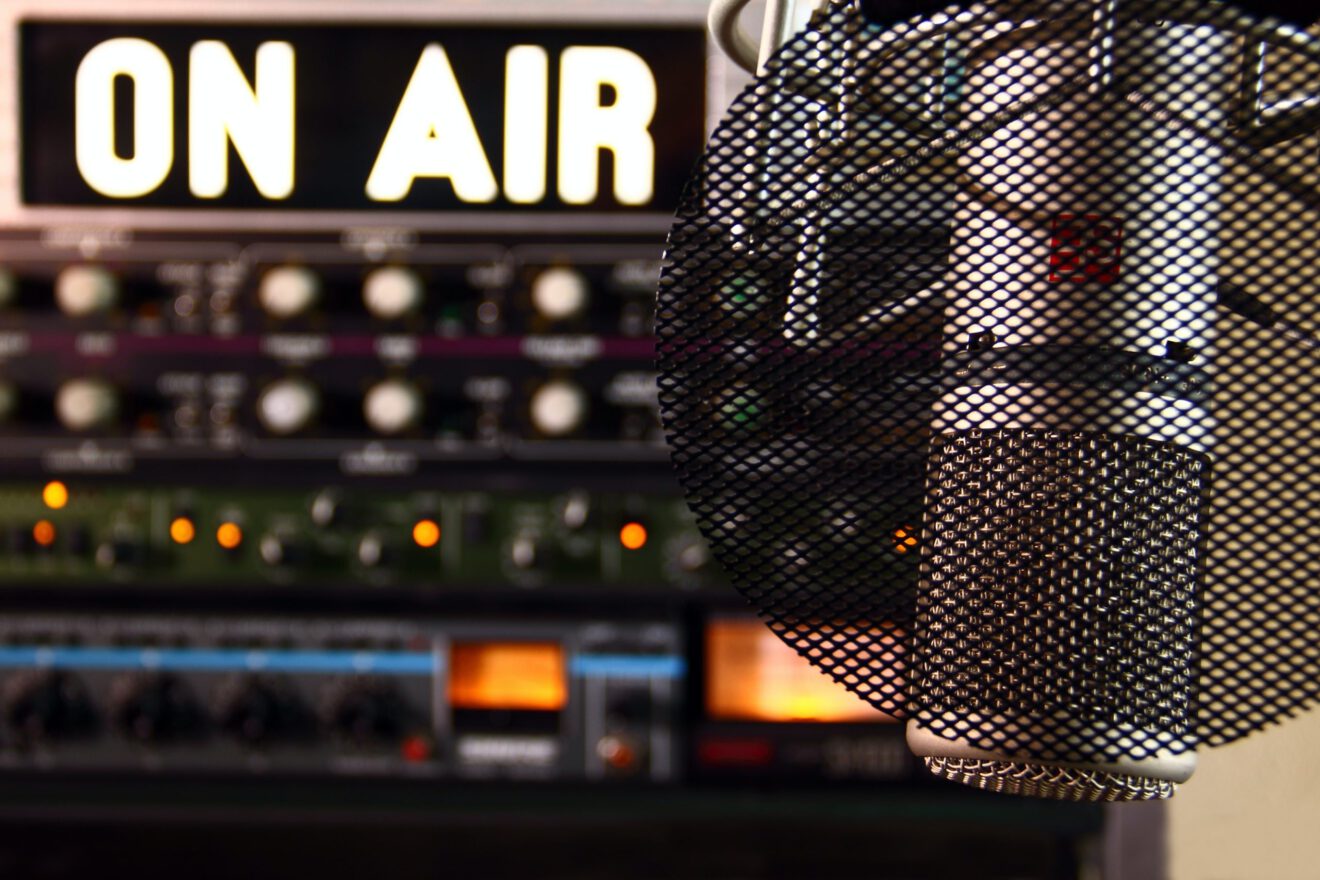A radio mic and an "on air" sign are shown.