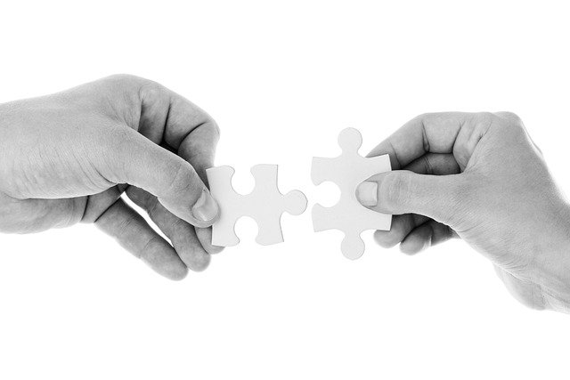 hands connecting puzzle pieces