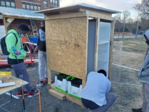 Two students building a mobile food pantry for problem-based learning article