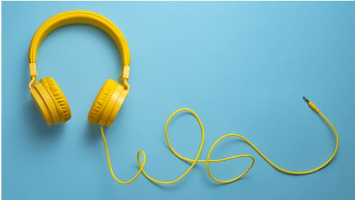 bright yellow headphones and cable on pale blue background for article on comfortable edtech tools