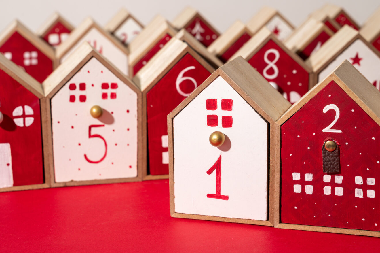 Handmade wooden advent calendar looks like small red and white houses, village or small city for article on bite-size professional learning