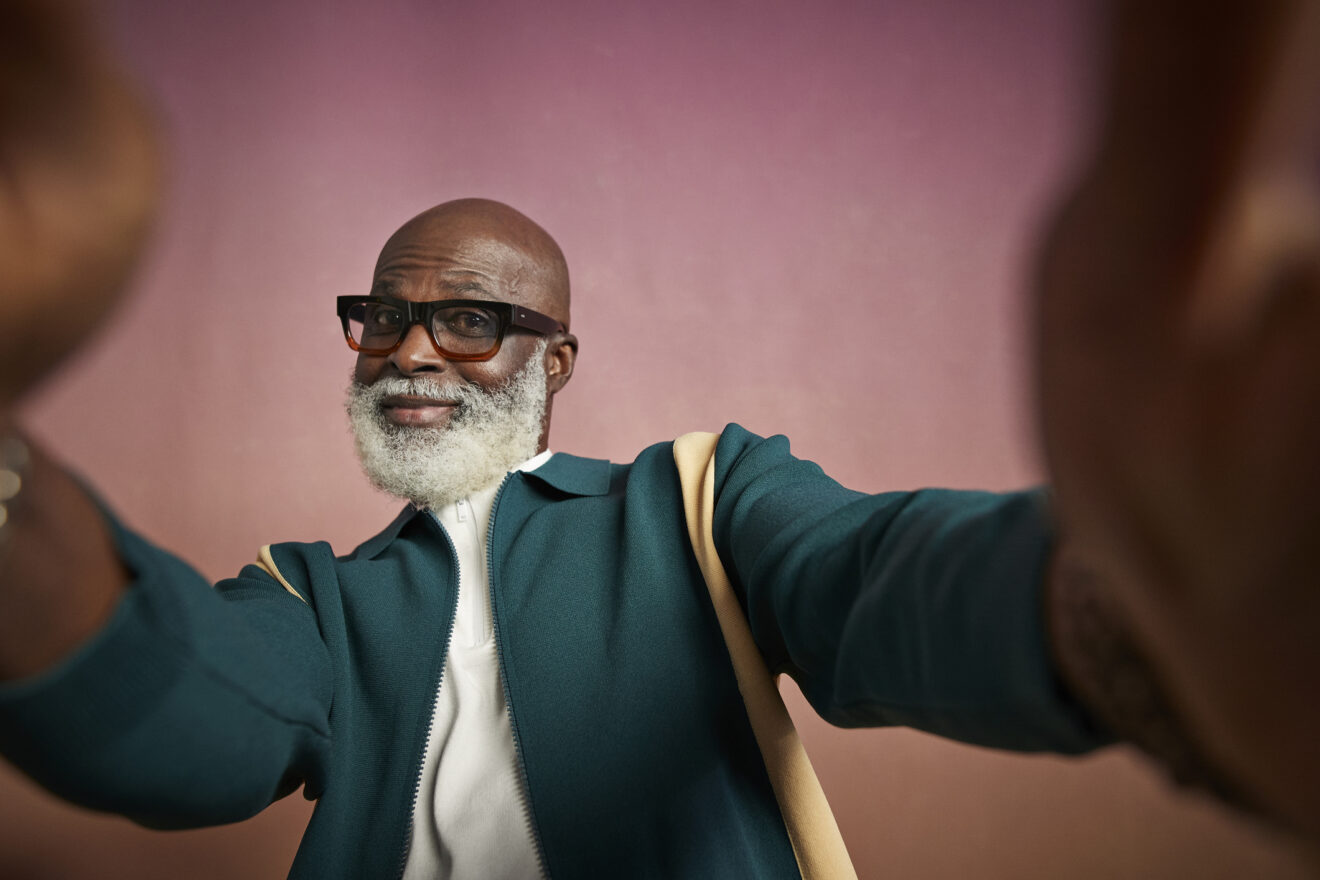 Portrait of elderly man with eyeglasses talking selfie in studio for article on joy of teachers