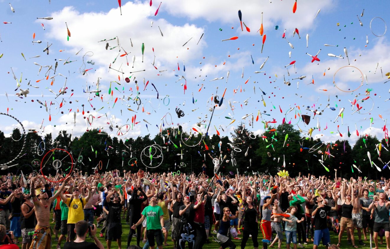 Image of many people with confetti and similar objects in the air Story: How experiential marketers can build community in these 3 cultures