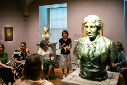 A room of busts at a museum with people for article on reading portraits.
