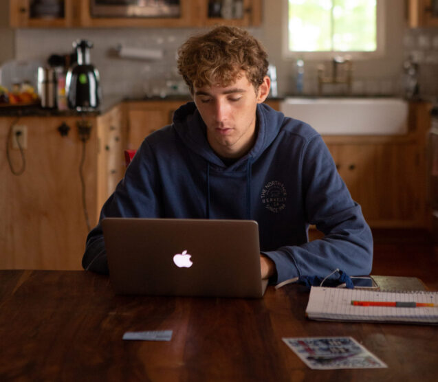 A high school remote learning student completes his schoolwork online from his home. for article on reading for older students