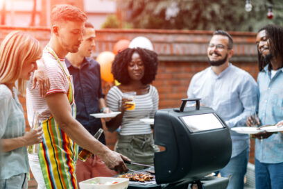 Young people grilling meat