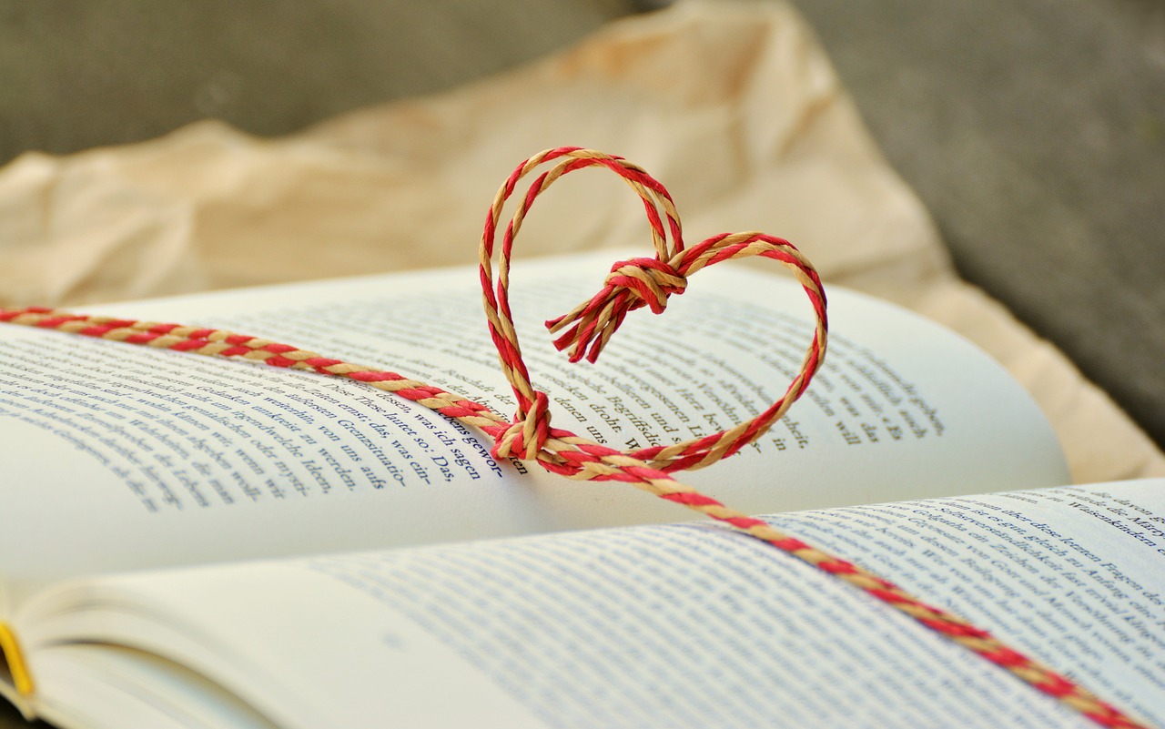 An open book with a heart bookmark