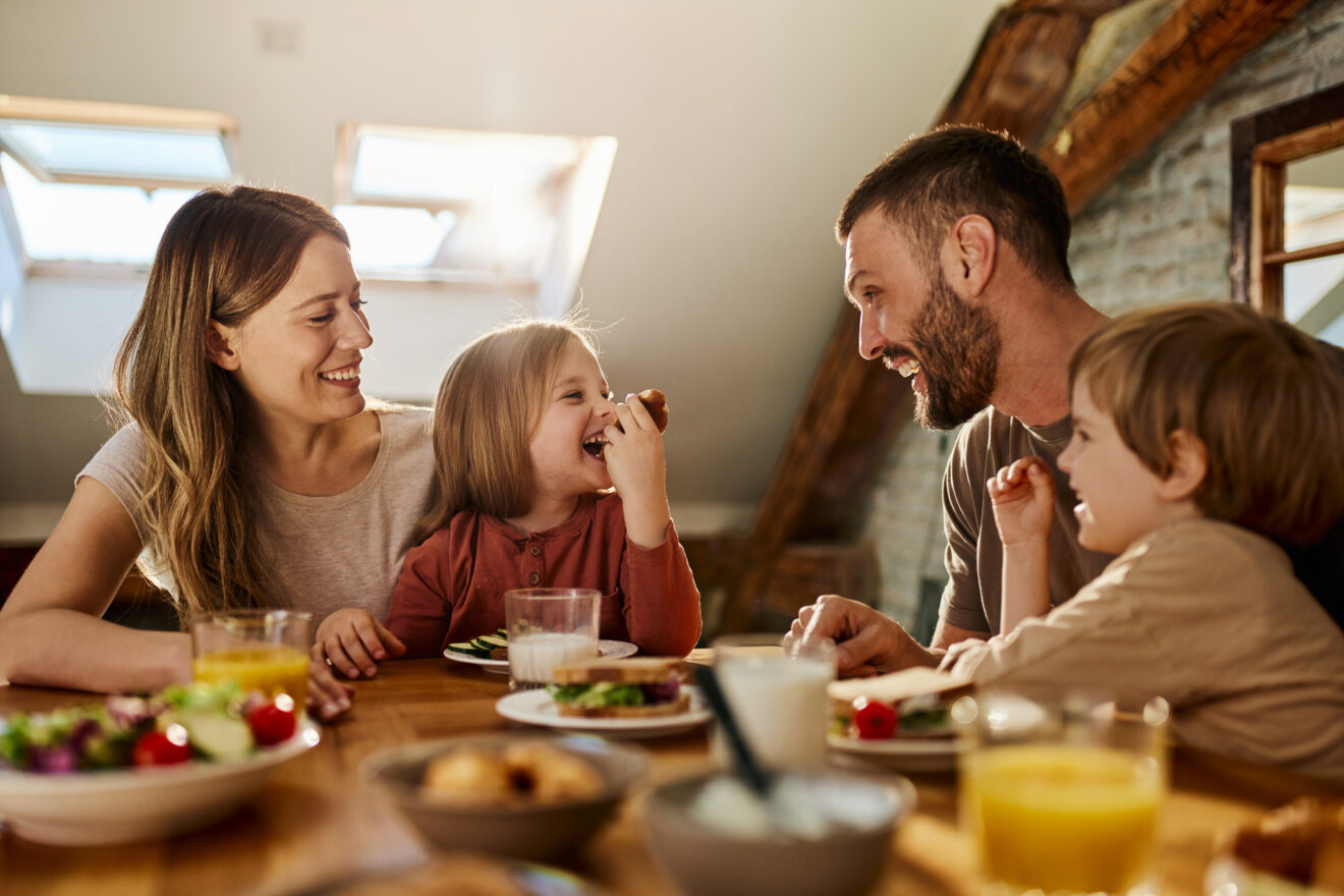 Family with young children having dinner together