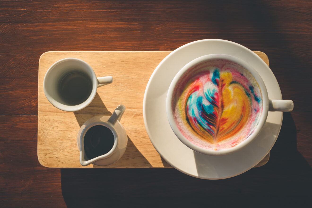Rainbow latte on a wooden board