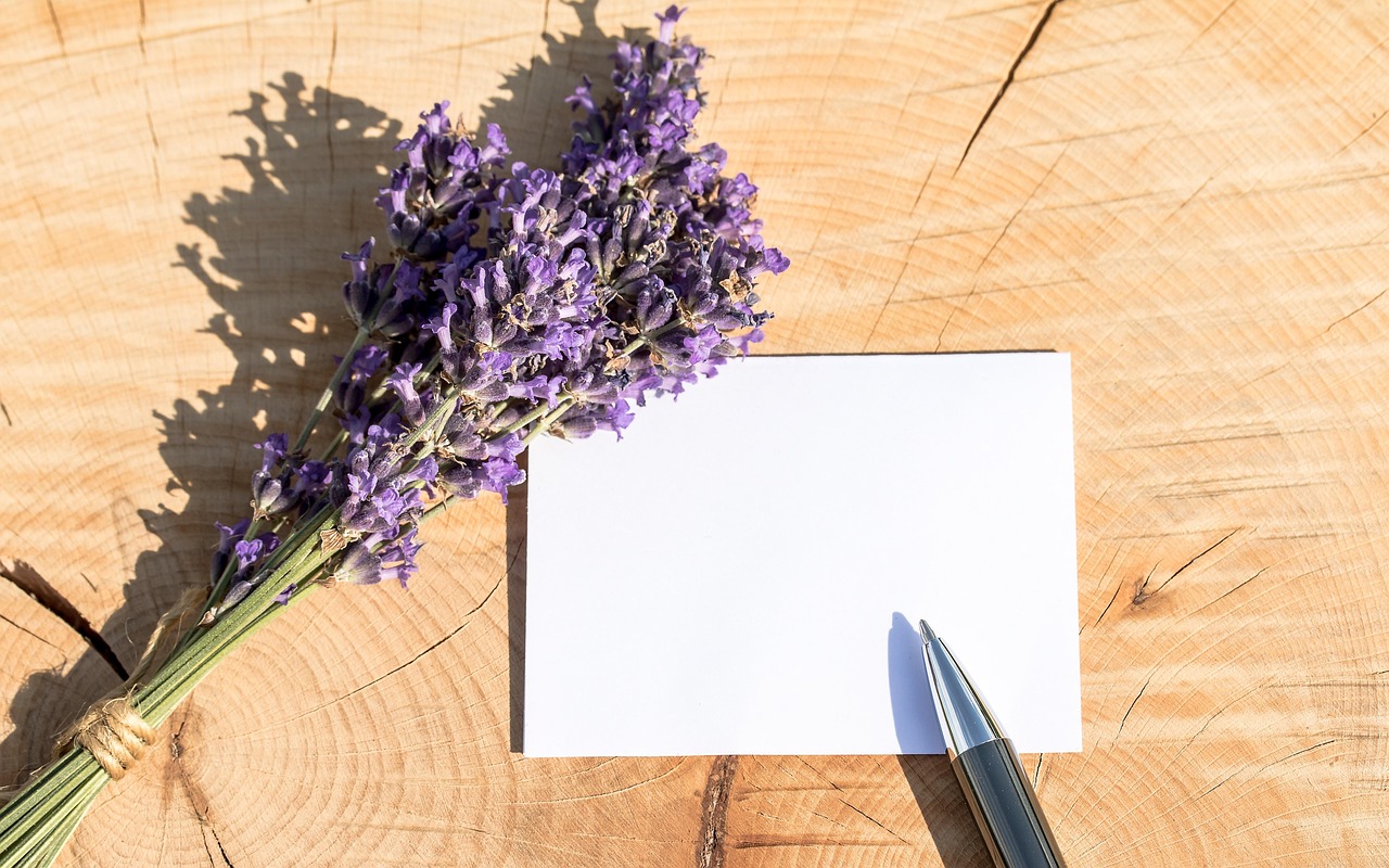 A blank note next to a bouquet of lavendar