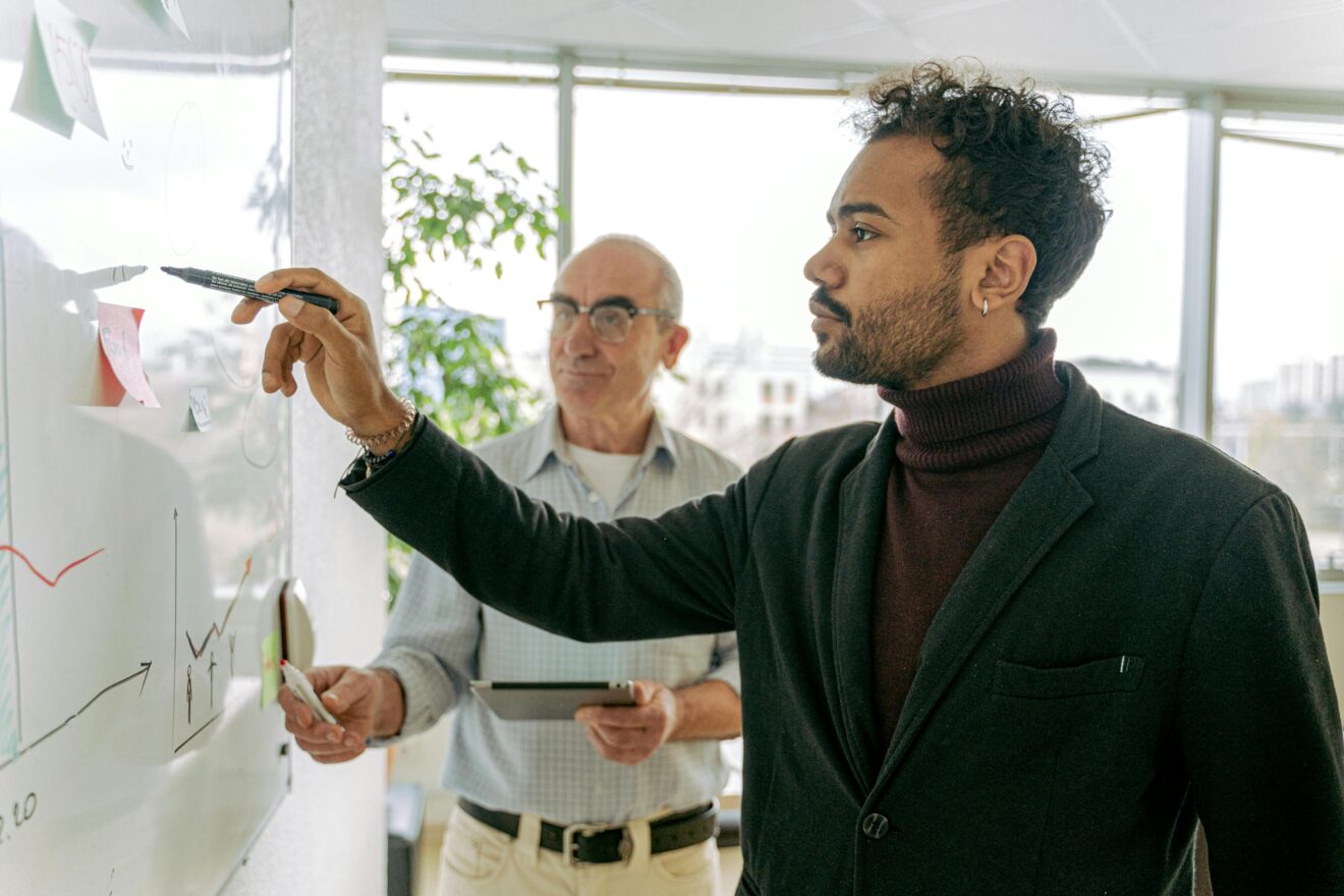 Two men at a whiteboard
