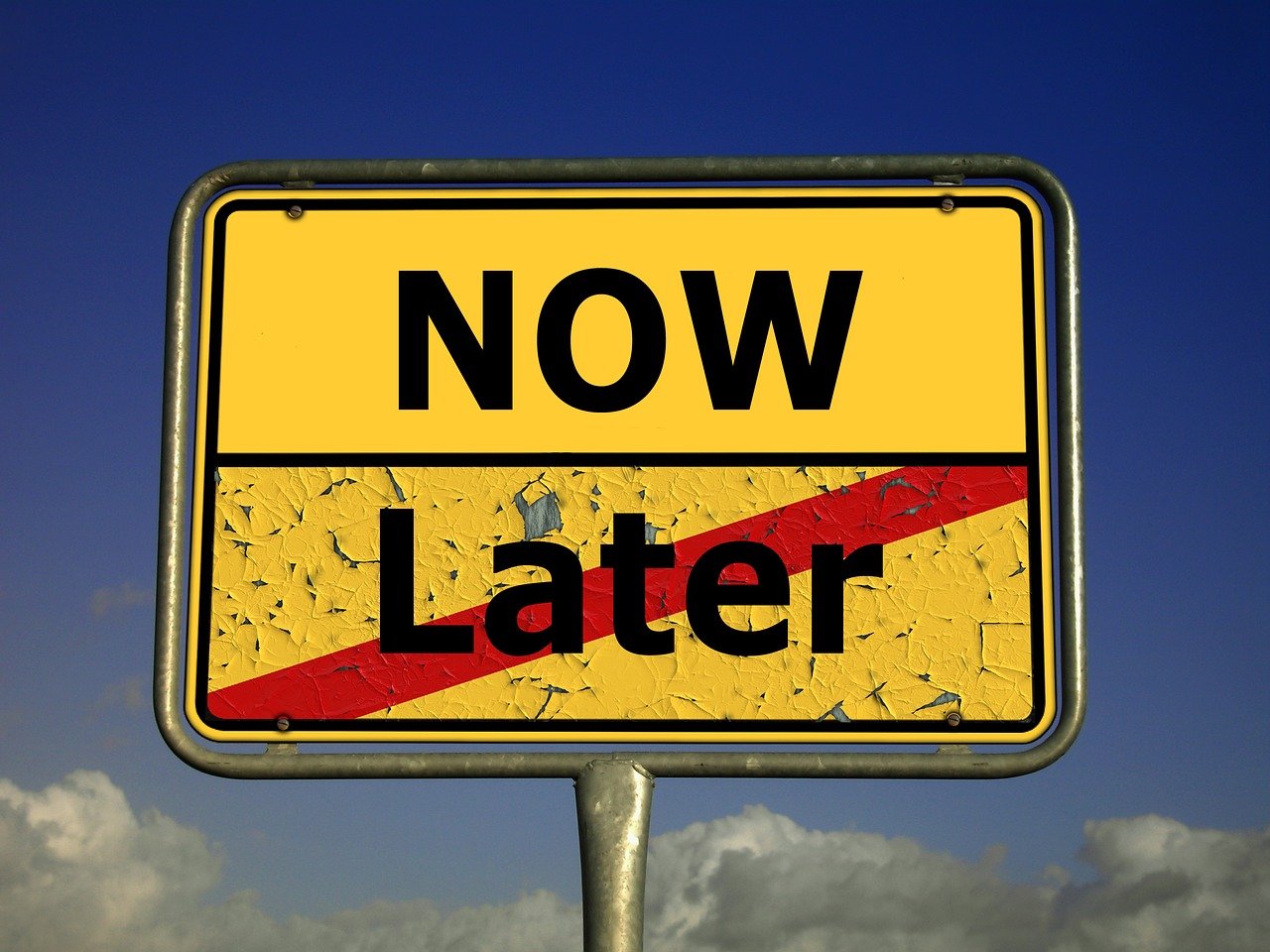 A sign reading "now" and "later"