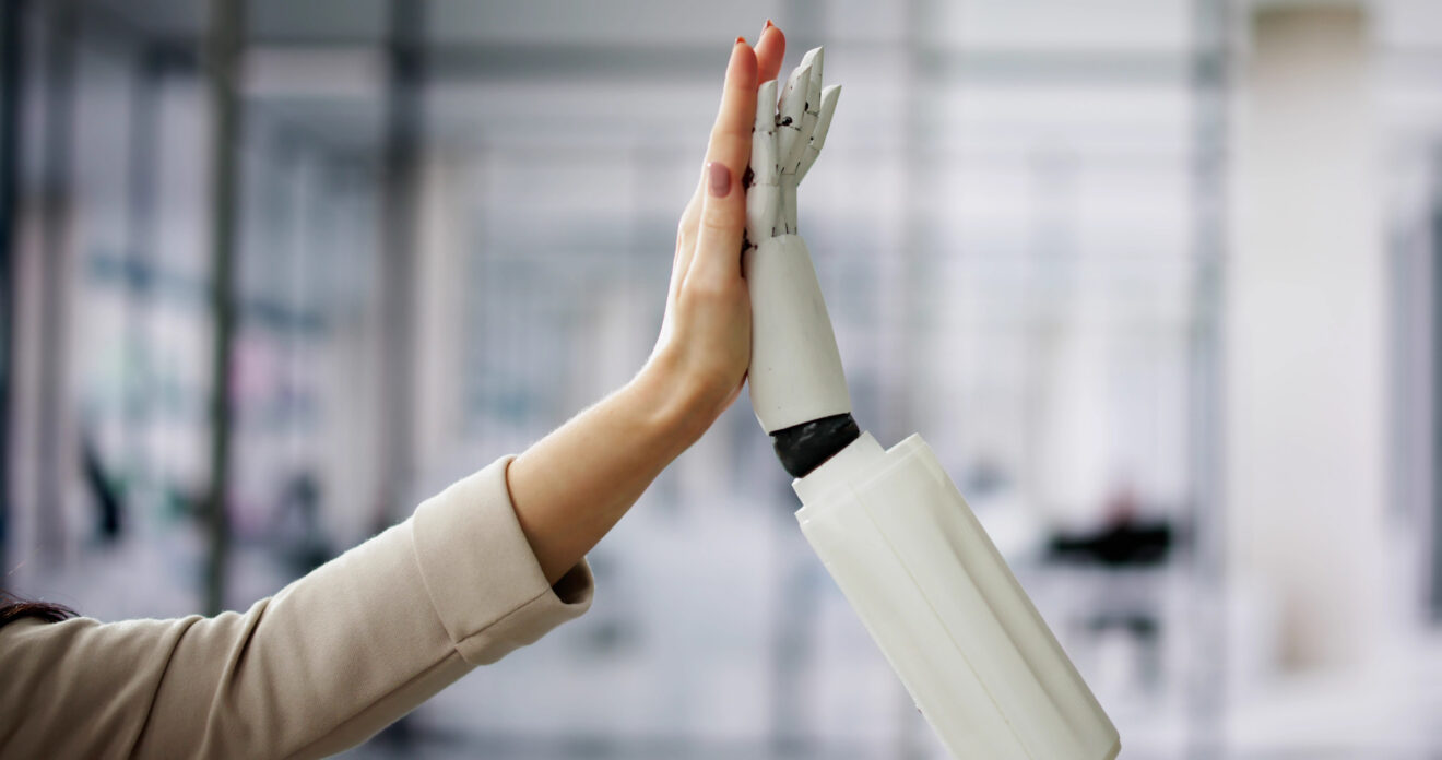 Arm and hand of a female (left) and same of a robot giving each other a high five. Image used for SmartBrief Original with headline: How AI redefines trust and personalization