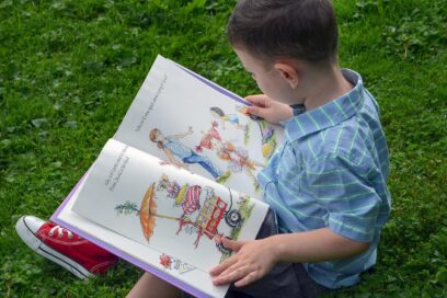 A young boy reading a picture book.