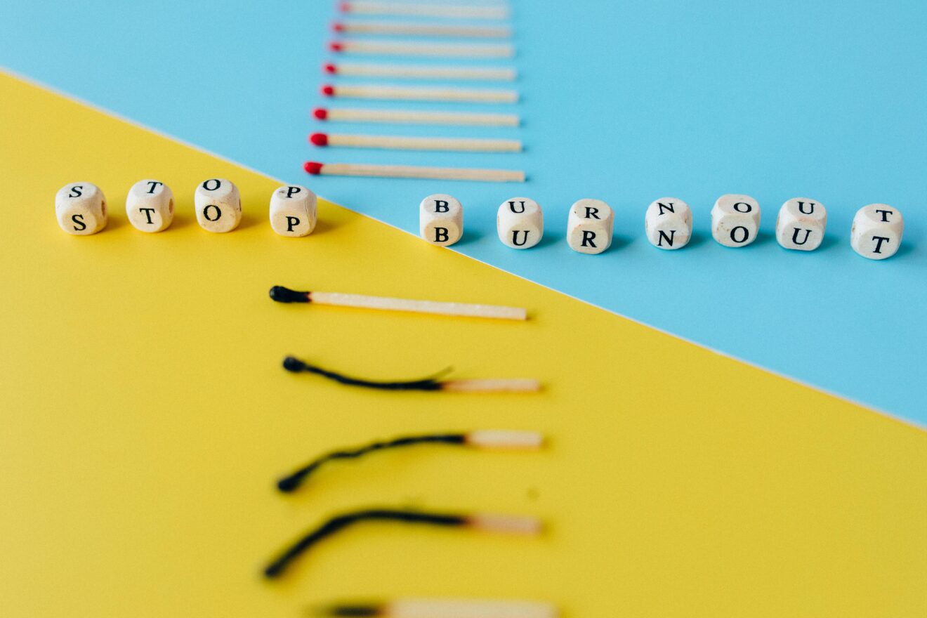 Vertical row of matches, with bottom ones burned out with top ones unlit, with "stop burnout" spelled out in dice between the two groups of matches. Used for SmartBrief article with headline: AI brain fry: What marketers need to know