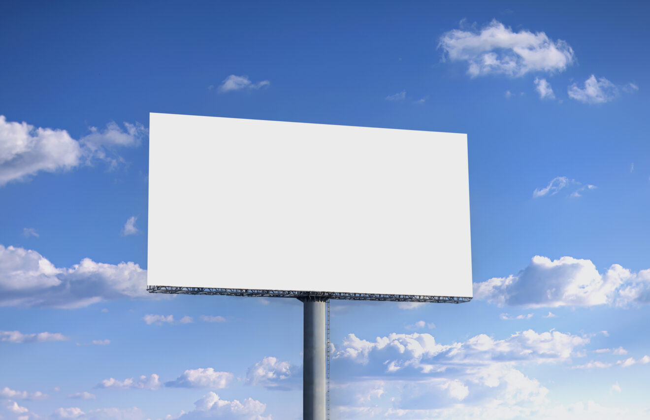 Blank billboard advertising banner media display and blue sky background Used for SmartBrief Marketing story headlined: What's in a (brand) name?