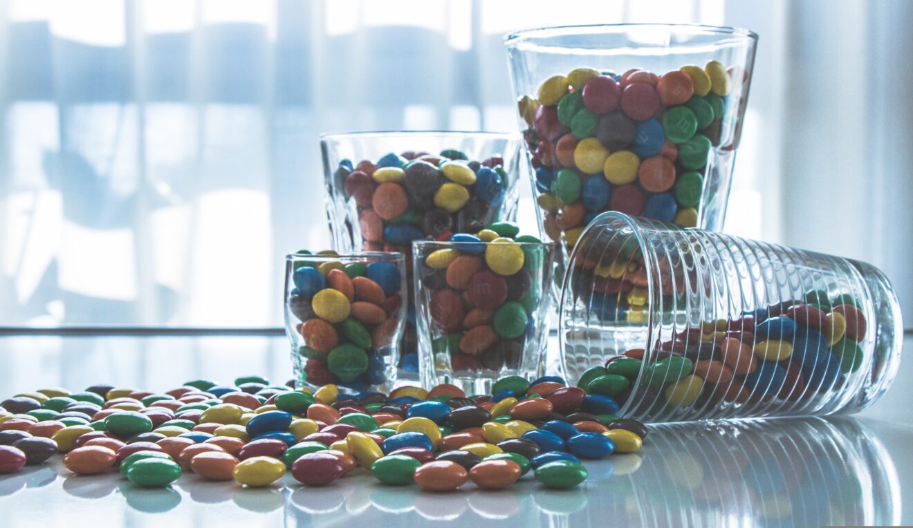A photo of glasses filled with chocolate candies.