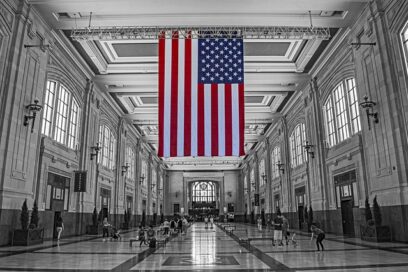 A black and white photo with an American flag in color.