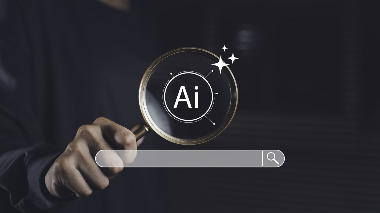 Magnifying glass focused on AI symbol with search bar, representing artificial intelligence technology used for smart search, digital exploration, and online data optimization. Used for SmartBrief Marketing Original on AI search engines, with headline: AI doesn’t care about your ad budget