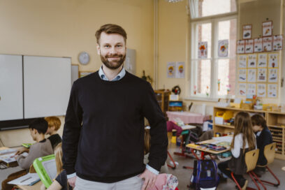 Man smiling standing in classroom