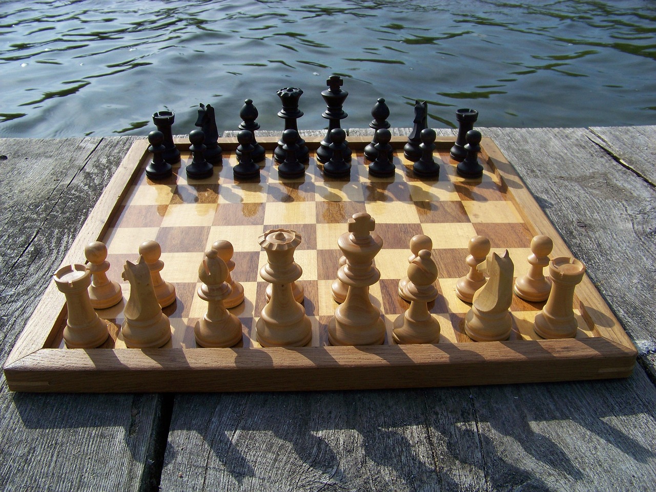 A chessboard set up on a dock.