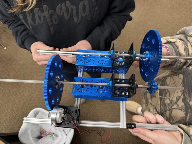 Team members tinker with a turbine gearbox as they prepare for the World KidWind Challenge. (Photo: Amanda Farris)