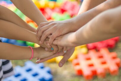 Children joining hands.