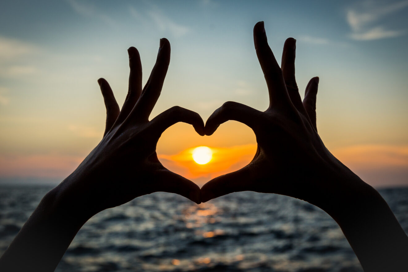 heart shape hand silhouette with sunset Used for SmartBrief Marketing Original with headline Adland’s summer crush: Are Creators different or just this year’s buzzword?