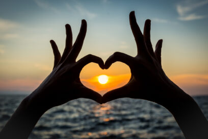 heart shape hand silhouette with sunset Used for SmartBrief Marketing Original with headline Adland’s summer crush: Are Creators different or just this year’s buzzword?