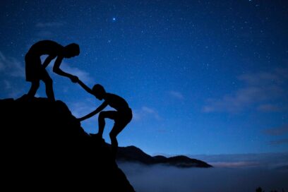 A helping hand climbing up a mountain.