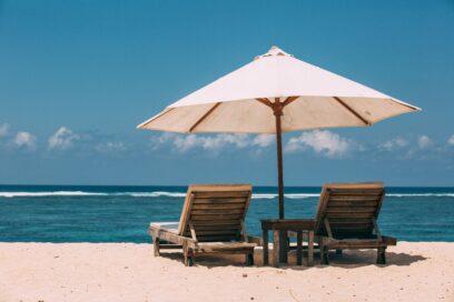 Two beach loungers on the sand.