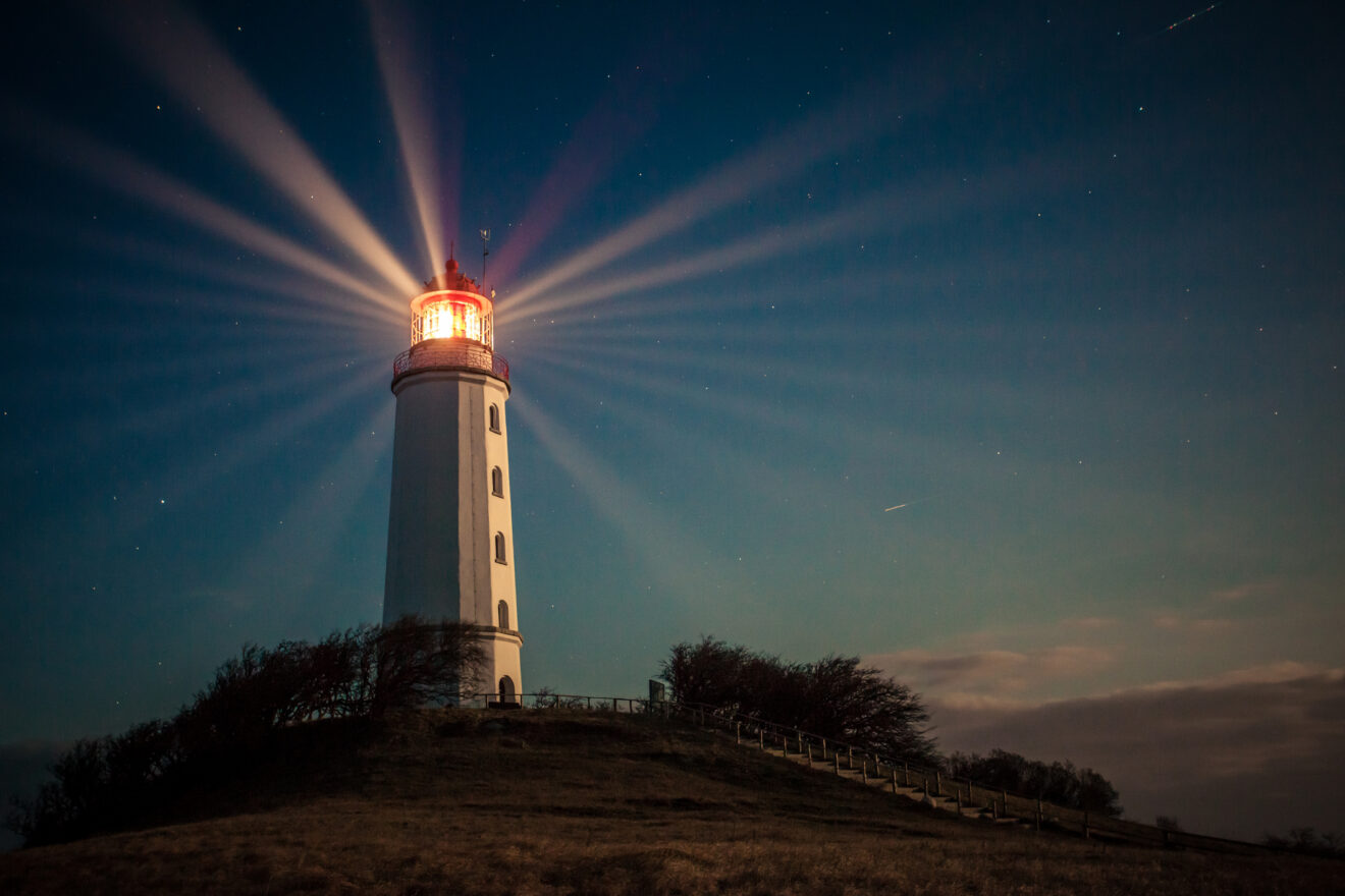Lighthouse on a hill shining at night - stock photo Hiddensee lighthouse shining at night on Dornbusch hill. Used for SmartBrief Marketing Original with headline Have brands optimized fame out of marketing?