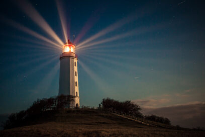 Lighthouse on a hill shining at night - stock photo Hiddensee lighthouse shining at night on Dornbusch hill. Used for SmartBrief Marketing Original with headline Have brands optimized fame out of marketing?