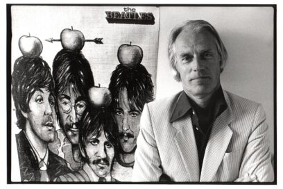 BELGIUM - JUNE 15: Photo of George MARTIN; posed, with poster of Beatles (Photo by Rob Verhorst/Redferns)
