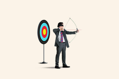 A blindfolded man with a bow and arrow and a target behind him aims in the wrong direction