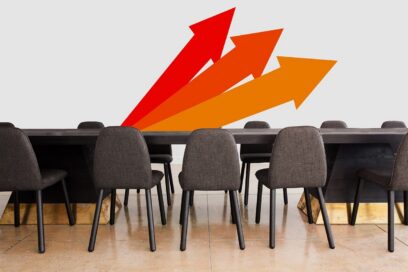 A photo of an empty board room with arrows pointing upwards.